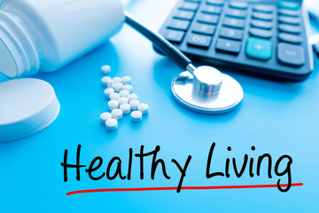 Healthy Living  Sign pills and medicines under a magnifying glass next to a medical stethoscope. The concept of health and responsible use of medicines, vitamins and various supplements