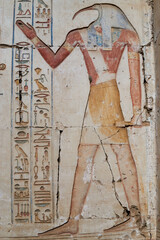 A wall relief of god Thoth, the patron of writing, with human body and Ibis head on the wall of the...