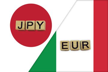 Japan and Italy currencies codes on national flags background