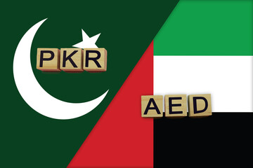 Pakistan and United Arab Emirates currencies codes on national flags background
