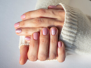 Fashionable pink manicure design in the hand.