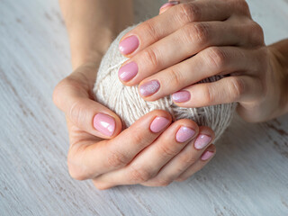 Fashionable pink manicure design in the hand.