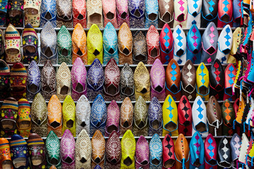 A stall in bazaar market with multi-colored leather slippers, filling the frame, Fez, Morocco