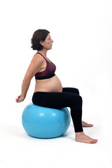 pregnant woman exercising with a ball on white background