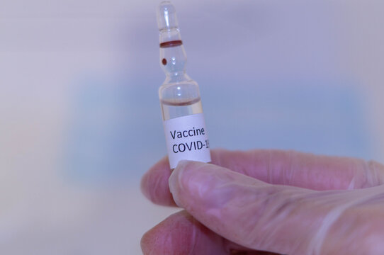 Medical doctor or laborant holding tube with nCoV Coronavirus vaccine