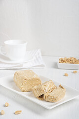 Side view of halva, also halvah or halwa is West Asia sweet dessert made of peanut oily seeds...