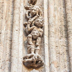 Fototapeta na wymiar Detalle de las figuras talladas en piedra alrededor del arco de la puerta de la Lonja de la Seda de Valencia, siglo XV.