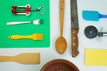 Background of kitchen utensils on white wooden kitchen table. tools. Top view.