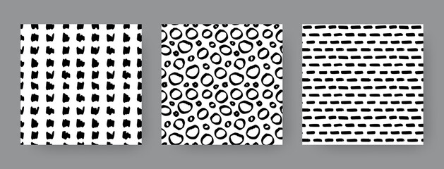 Set of hand-drawn seamless black and white patterns with circles, dashes and stripes. Vector backgrounds.
