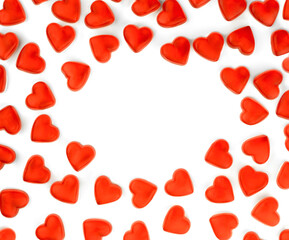 Fototapeta na wymiar Red hearts on white background. Frame of sweets. Place for your text