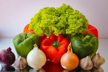 Prepare for a wonderful vegetarian lunch. Washed bell peppers, onions, garlic and lettuce leaves