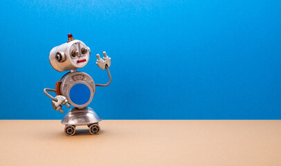 Metallic chat bot robot on blue beige background. Silver color domestic robotic roller with empty blue interface on body. Creative design steampunk toy, copy space