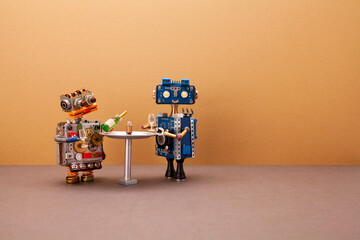 Two happy robots are preparing to drink sparkling wine at a bar table. Creative design mechanical...
