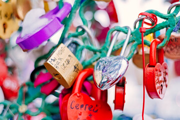 Many bright, colored  iron  love romantic padlocks, wedding padlocks, love locks. Symbol of eternal...