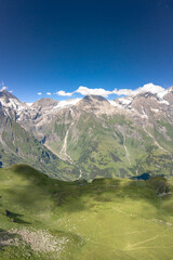 Aerial drone shot of cattle heard on meadow with Grossglockner mountain range view in Austria