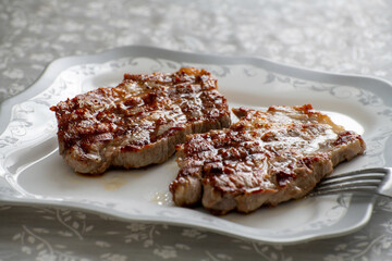 The Grilled pork steaks on a plate