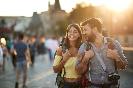 Happy tourist couple sightseeing; Traveller lifestyle
