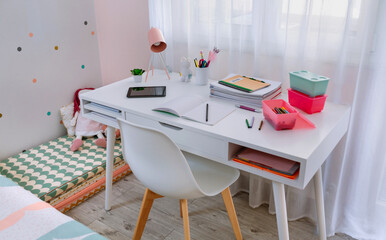 White desk in girl's bedroom decorated in pastel colors