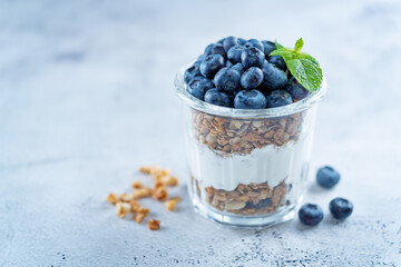 Fototapeta na wymiar Blueberry Greek yogurt granola parfait in a glass