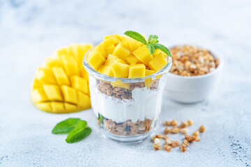 Mango Greek yogurt granola parfait in a glass