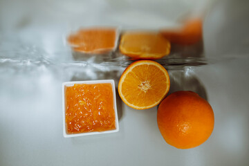 unusual still life with oranges and jam, reflection, abstraction