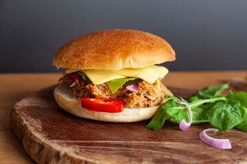 Fresh Pulled pork sandwich with pickled cucumber, arugula and jalapenos