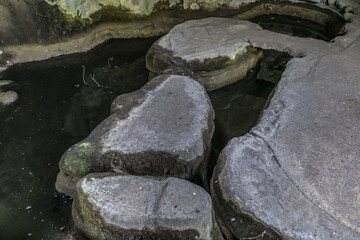 Grotto in Parc des Buttes-Chaumont - Public Park opened in 1867; it is fifth-largest park in Paris. Grotto - vestige of old gypsum and limestone quarry. Paris, France.