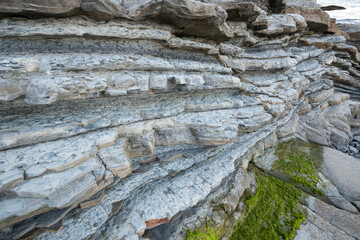 Closeup image of geological formation flysch made of stone sheets in horizontal.