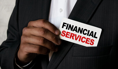 Close up view of a black man holding a business card. A young African businessman takes out a business card from the pocket of his business suit. Business concept and marketing.