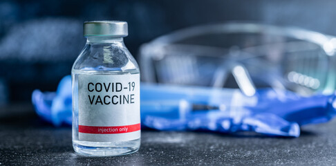 A single bottle vial of Covid-19 vaccine. Medical concept vaccination hypodermic injection...