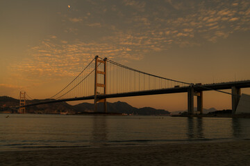 Fototapeta na wymiar View Of Suspension Bridge At Sunset