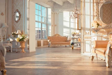 Fotobehang Hotel chique rich apartment interior with golden baroque decorations on the walls and luxury furniture. the room is flooded with the rays of the setting sun  © 4595886