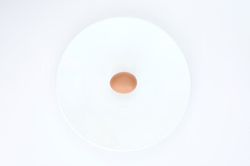 Isolated egg on a white plate on a white background