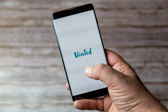 02-05-2021 Portsmouth, Hampshire, UK A Mobile phone or cell phone being held showing the Vinted app open on screen