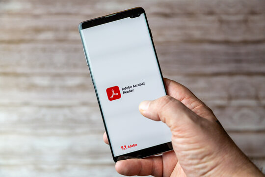 02-05-2021 Portsmouth, Hampshire, UK A Mobile phone or cell phone being held showing the Adobe acrobat reader app open on screen