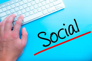 Social Sign Working at home with computer man writing. Man hands on the keyboard. Isolated on blue background.   Business concept. Stock Photo