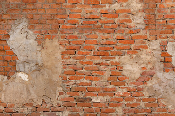 Old red brick wall with cracks. 