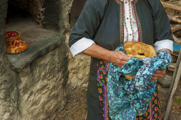 baking easter bread in an antique oven in the village of Olympos, Karpathos island, Greece