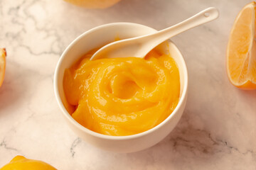 Homemade fresh pudding or tangy lemon curd in a white bowl.Selective focus