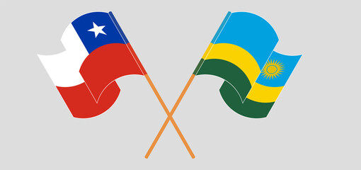 Crossed and waving flags of Chile and Rwanda