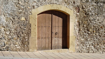 rustic wood door on stone facade