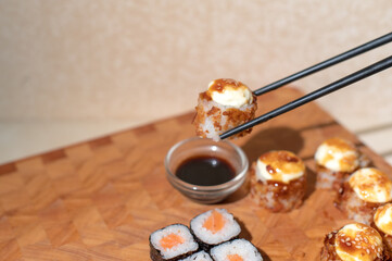 Sushi set. Hand with chopsticks
