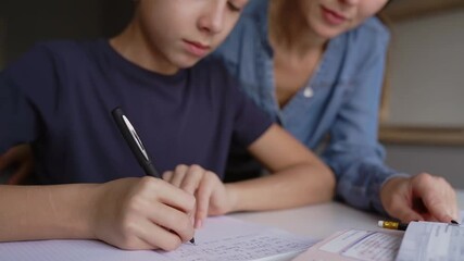 Mom and adult son teach homework at home, mom helps son do homework, sister helps teach lessons to teenager, study at home, beautiful mom and handsome adult son study at home