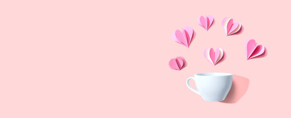 Coffee cup with paper craft hearts - flat lay