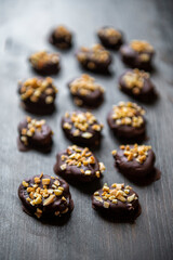 Dried apricots in chocolate sprinkled with nuts.
