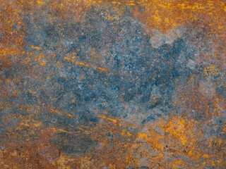 Metal plate with weathered colors and rust. Natural light. Blue and orange metal plate. Old oxidized colorful textured surface. Abstract grunge rusty metallic background for multiple uses. Corrosion.