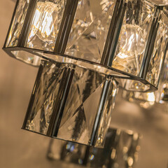 Close-up of the glowing expensive chandelier from a crystal ceiling lampshade. Classic style in a...