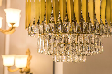 Close up of the luminous luxury expensive chandelier from a glass ceiling lampshade. Classic style...
