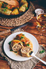 Two Cabbage Rolls Stuffed with Minced Meat and Rice on White Plate Served with Chopped Parsley