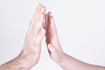 The man's hand tries to touch the woman's hand